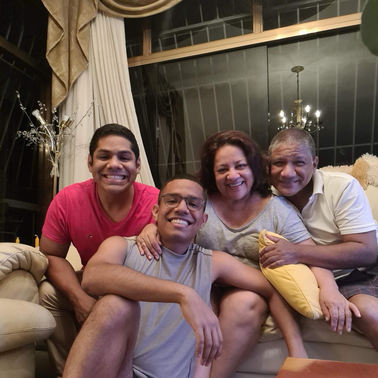 My parents and brother on the living room couch in Caracas