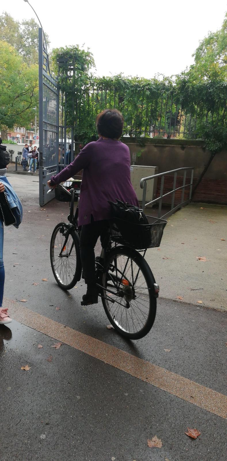 Mme. Pechoux riding home on her bicycle after class